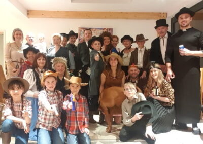 A group in wild west costumes for our Way out West murder mystery party game.