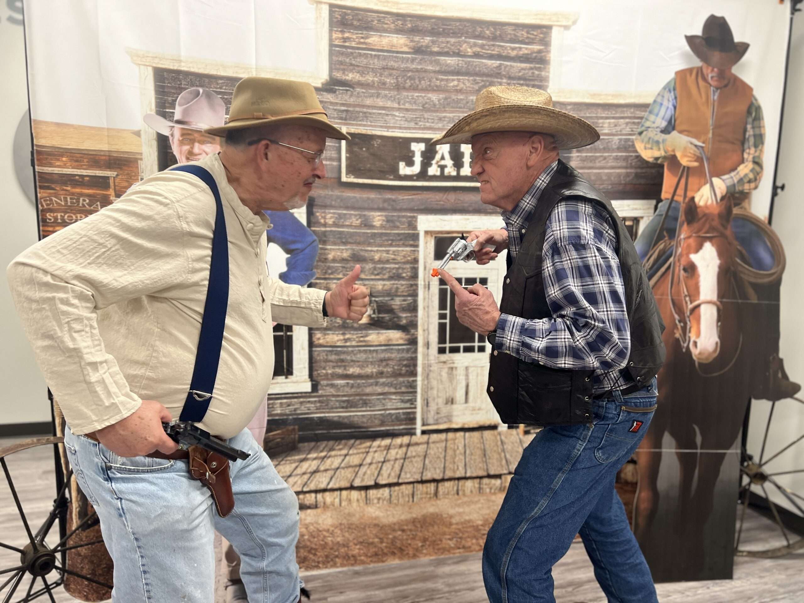 Two people playing at being gunfighters face each other in a Wild West murder mystery game