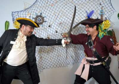 Two people duelling in pirate costume