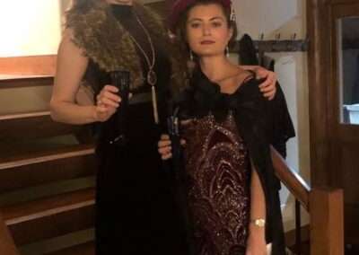 A couple in costume for the A Will to Murder murder mystery game