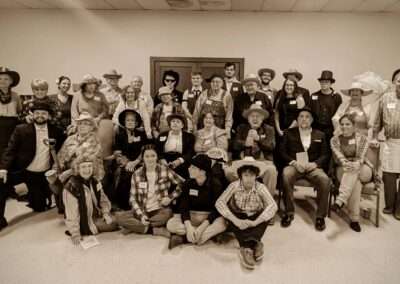 Sepia-toned photo of a group in costume for Way out West murder mystery game