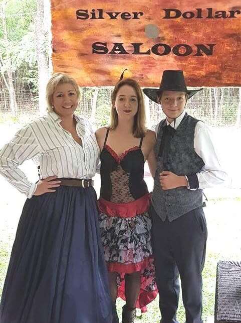 Three people in Wild West costumes for Way out West murder mystery game