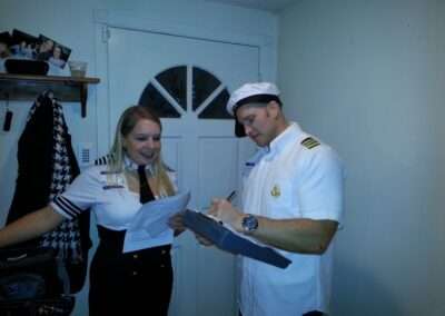 Players in costume playing our Murder at Sea murder mystery party.